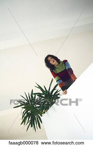 Woman looking down from mezzanine View Large Photo Image Stock Photo - Woman looking down from mezzanine. Fotosearch
