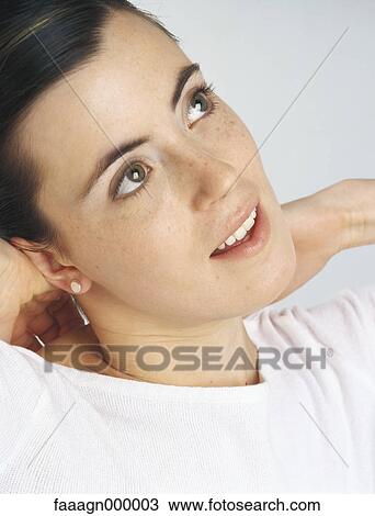 Stock Image - Woman looking up, portrait. Fotosearch
