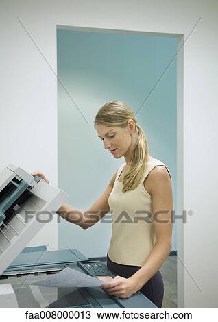 Woman making photocopies in office View Large Photo Image Stock Image - Woman making photocopies in office. Fotosearch