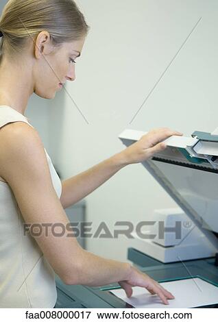 Woman making photocopies in office View Large Photo Image Stock Photo - Woman making photocopies in office. Fotosearch