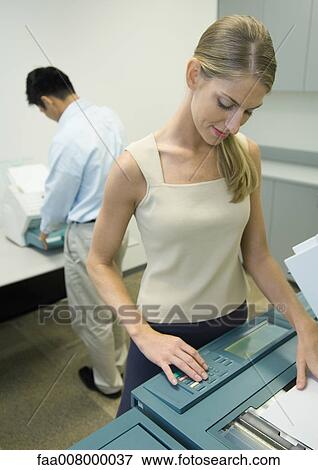 Woman making photocopies in office View Large Photo Image Stock Photo - Woman making photocopies in office. Fotosearch