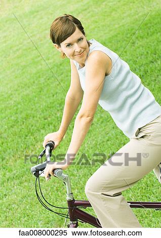 Woman on bike, smiling View Large Photo Image Stock Photography - Woman on bike, smiling. Fotosearch