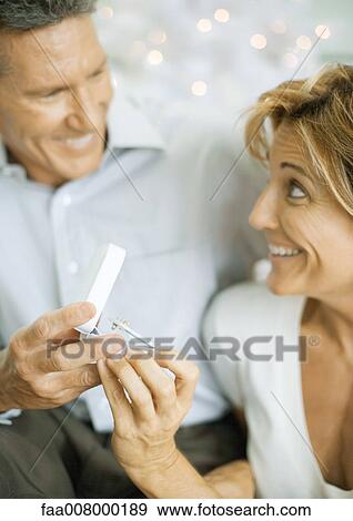 Woman opening christmas gift View Large Photo Image Stock Photo - Woman opening christmas gift. Fotosearch