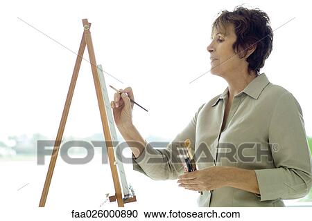 Woman painting on canvas, side view, close-up View Large Photo Image Stock Image - Woman painting on canvas, side view, close-up. Fotosearch