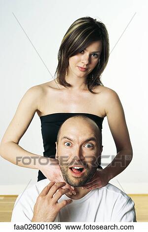 Woman pretending to strangle man, both looking at camera View Large Photo Image Stock Photograph - Woman pretending to strangle man, both looking at camera. Fotosearch