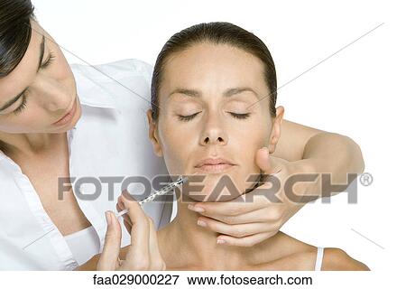 Woman receiving Botox injection, eyes closed View Large Photo Image Stock Photo - Woman receiving Botox injection, eyes closed. Fotosearch