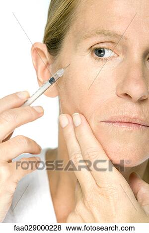 Woman receiving Botox injection, cropped view View Large Photo Image Stock Photo - Woman receiving Botox injection, cropped view. Fotosearch