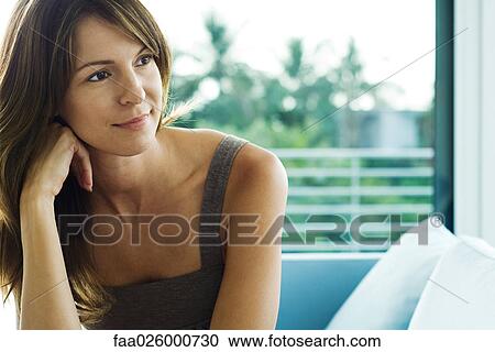 Woman resting head on hand, looking away, waist up View Large Photo Image Stock Image - Woman resting head on hand, looking away, waist up. Fotosearch