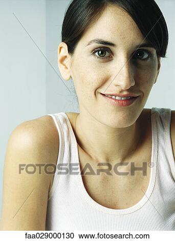 Stock Image - Woman smiling at camera, portrait. Fotosearch