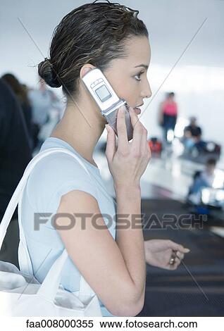 Woman using cell phone, side view View Large Photo Image Stock Photography - Woman using cell phone, side view. Fotosearch