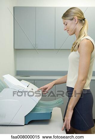 Woman using fax machine in office View Large Photo Image Stock Photography - Woman using fax machine in office. Fotosearch