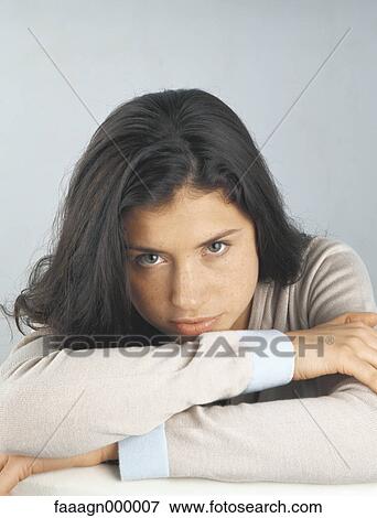 Woman with head down on arms, portrait View Large Photo Image Stock Photo - Woman with head down on arms, portrait. Fotosearch