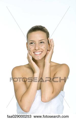 Woman with plastic surgery markings on face, holding head, smiling View Large Photo Image Stock Image - Woman with plastic surgery markings on face, holding head, smiling. Fotosearch
