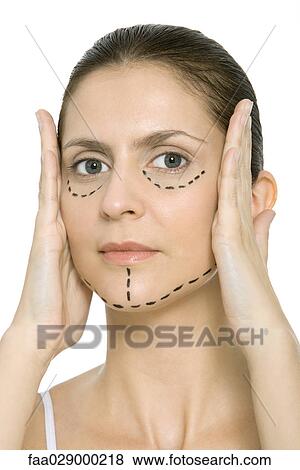 Woman with plastic surgery markings on face, holding face in hands, looking at camera View Large Photo Image Stock Photo - Woman with plastic surgery markings on face, holding face in hands, looking at camera. Fotosearch
