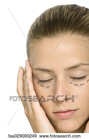 Woman with plastic surgery markings under eyes, holding face, eyes closed View Large Photo Image Stock Photo - Woman with plastic surgery markings under eyes, holding face, eyes closed. Fotosearch
