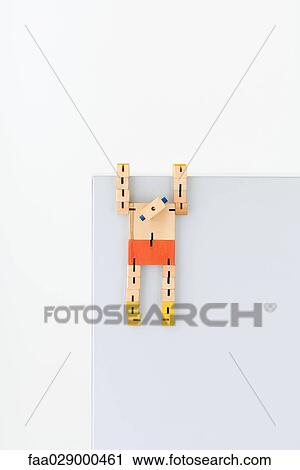 Wooden robot hanging from ledge View Large Photo Image Stock Image - Wooden robot hanging from ledge. Fotosearch