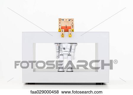 Wooden robot looking down at metallic robot shaking below View Large Photo Image Stock Photo - Wooden robot looking down at metallic robot shaking below. Fotosearch
