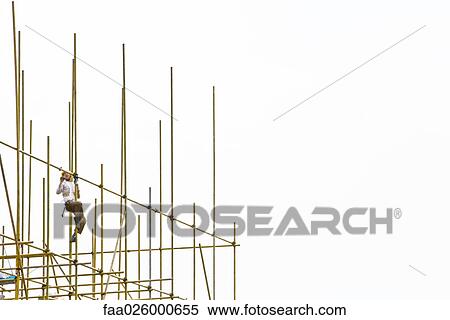 Worker on scaffolding, low angle view View Large Photo Image Stock Photography - Worker on scaffolding, low angle view. Fotosearch