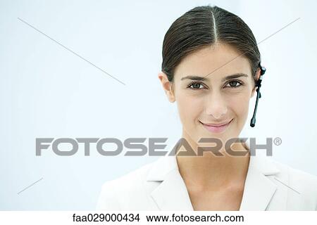 Young businesswoman wearing headset, portrait View Large Photo Image Picture - Young businesswoman wearing headset, portrait. Fotosearch