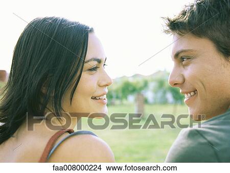 Young couple gazing at each other View Large Photo Image Picture - Young couple gazing at each other. Fotosearch