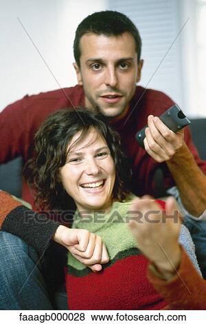 Young couple with remote control View Large Photo Image Stock Photo - Young couple with remote control. Fotosearch