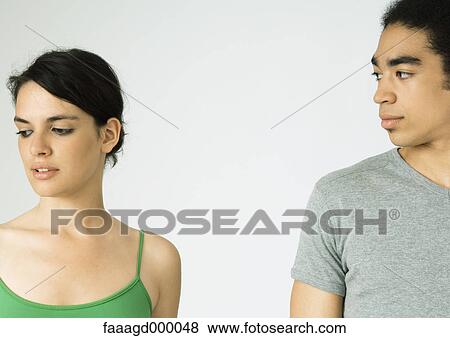 Young couple, woman looking away, man looking at woman View Large Photo Image Stock Photo - Young couple, woman looking away, man looking at woman. Fotosearch