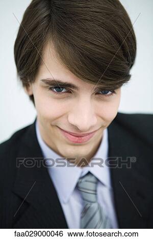 Young man in suit smiling at camera, portrait View Large Photo Image Stock Photograph - Young man in suit smiling at camera, portrait. Fotosearch