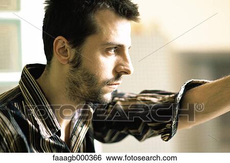 Stock Photograph - Young man, side view. Fotosearch