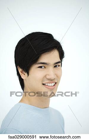 Young man smiling at camera, portrait View Large Photo Image Stock Image - Young man smiling at camera, portrait. Fotosearch