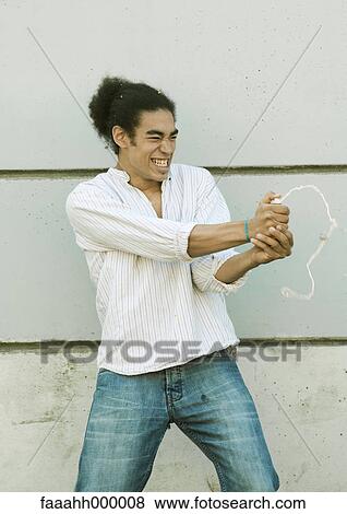 Young man squirting party string View Large Photo Image Stock Photo - Young man squirting party string. Fotosearch