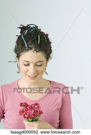 Young woman holding small bouquet of flowers View Large Photo Image Stock Image - Young woman holding small bouquet of flowers. Fotosearch