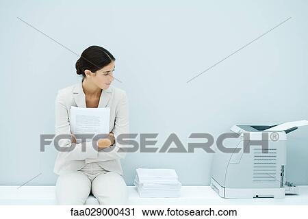 Young woman in suit sitting next to printer View Large Photo Image Stock Image - Young woman in suit sitting next to printer. Fotosearch