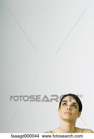 Young woman looking up View Large Photo Image Picture - Young woman looking up. Fotosearch