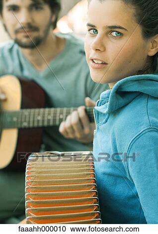 Young woman playing accordian and young man playing guitar View Large Photo Image Stock Image - Young woman playing accordian and young man playing guitar. Fotosearch