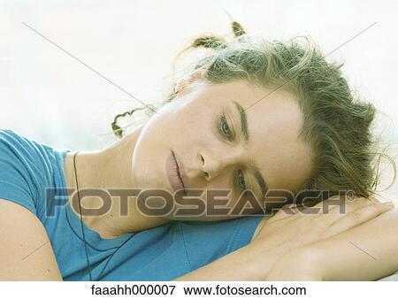 Young woman resting head on arm View Large Photo Image Stock Photo - Young woman resting head on arm. Fotosearch