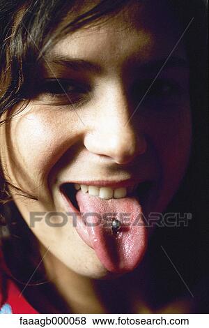 Young woman showing tongue piercing View Large Photo Image Stock Photo - Young woman showing tongue piercing. Fotosearch