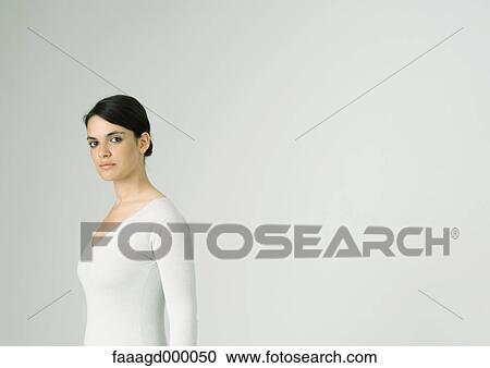 Young woman standing, looking at camera View Large Photo Image Stock Image - Young woman standing, looking at camera. Fotosearch