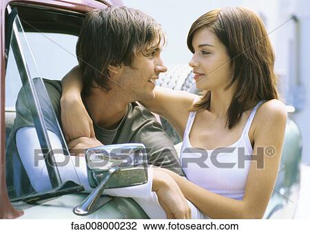 Young woman standing next to pick-up truck with arm around boyfriend in driver's seat View Large Photo Image Stock Image - Young woman standing next to pick-up truck with arm around boyfriend in driver's seat. Fotosearch