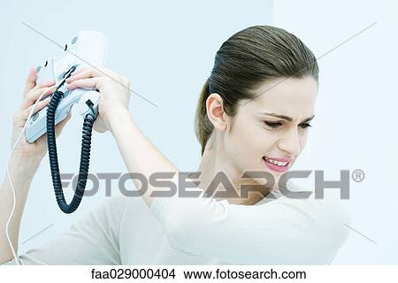 Young woman throwing landline phone View Large Photo Image Picture - Young woman throwing landline phone. Fotosearch