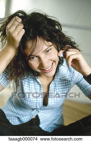Young woman using cell phone View Large Photo Image Picture - Young woman using cell phone. Fotosearch