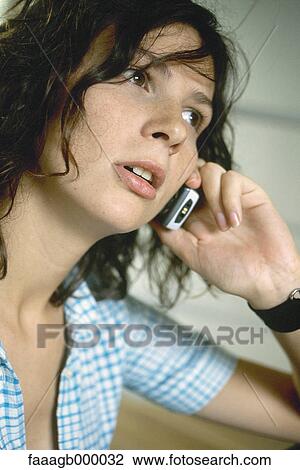 Young woman using cell phone View Large Photo Image Stock Image - Young woman using cell phone. Fotosearch