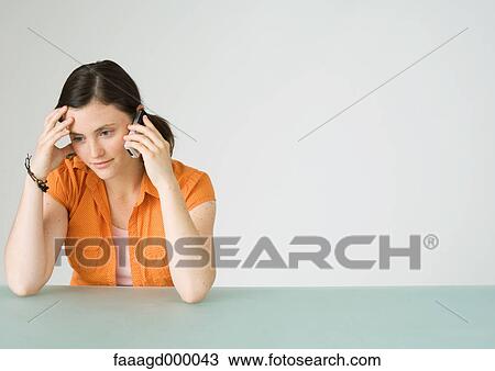 Young woman using cell phone View Large Photo Image Stock Image - Young woman using cell phone. Fotosearch