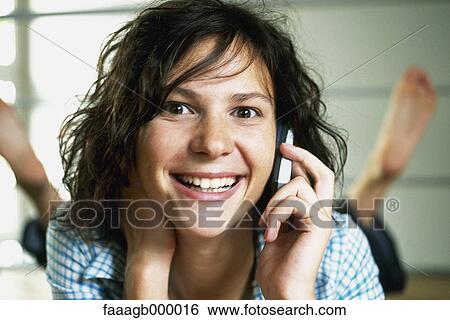 Young woman using cell phone View Large Photo Image Stock Photograph - Young woman using cell phone. Fotosearch