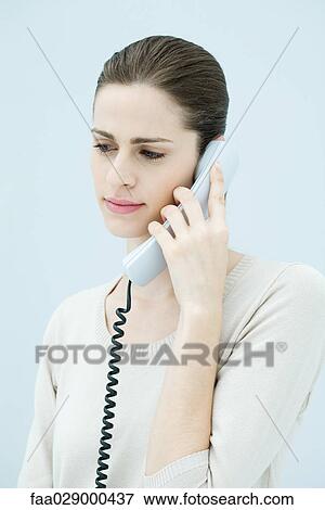 Young woman using landline telephone View Large Photo Image Stock Photo - Young woman using landline telephone. Fotosearch