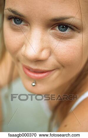Young woman with facial piercing, close-up View Large Photo Image Stock Image - Young woman with facial piercing, close-up. Fotosearch