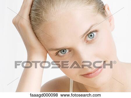 Young woman with hand on head View Large Photo Image Stock Photo - Young woman with hand on head. Fotosearch