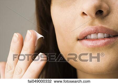 Applying facial moisturizer View Large Photo Image Stock Image - Applying facial moisturizer. Fotosearch