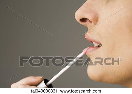 Applying lip-gloss with lip brush View Large Photo Image Stock Image - Applying lip-gloss with lip brush. Fotosearch