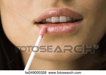 Applying lip-gloss with lip brush View Large Photo Image Stock Photo - Applying lip-gloss with lip brush. Fotosearch