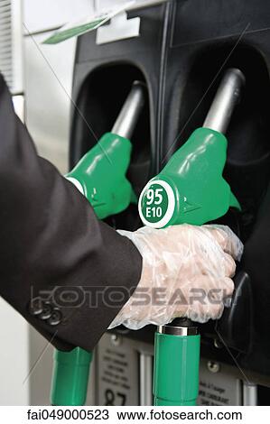 At gas pump with gloved hand removing nozzle View Large Photo Image Stock Image - At gas pump with gloved hand removing nozzle. Fotosearch